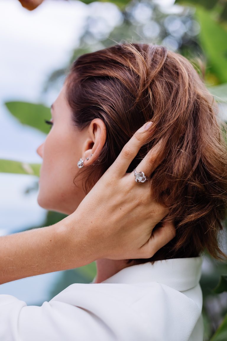 1-fashion-portrait-woman-tropical-luxury-villa-wearing-white-stylish-blazer-jewellery-tropical-leaves-scaled